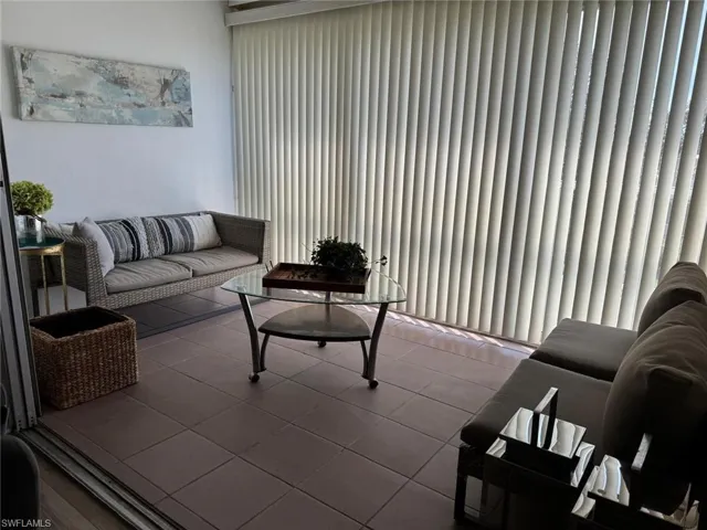Living room with light tile patterned flooring
