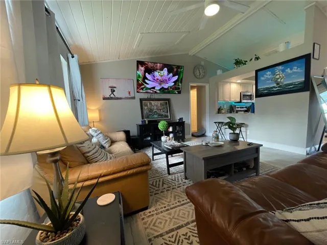 Living room with ceiling fan and baseboards