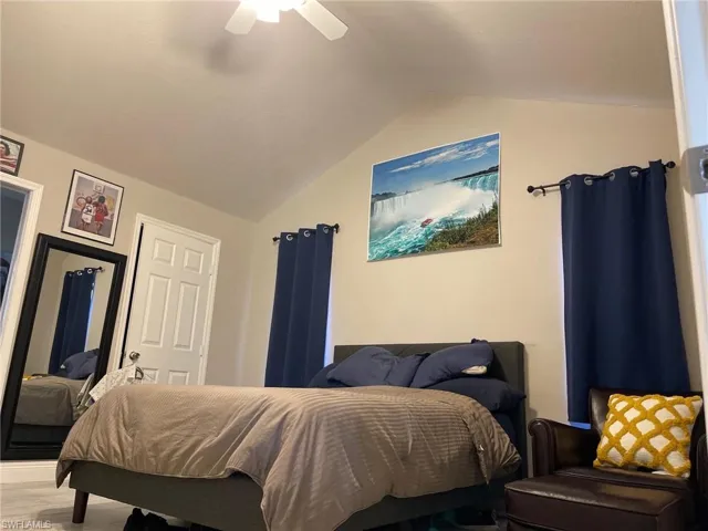 Bedroom featuring lofted ceiling and a ceiling fan