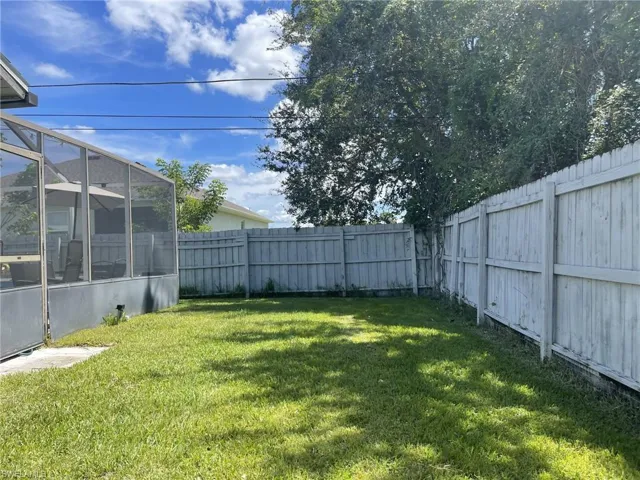 View of yard featuring glass enclosure