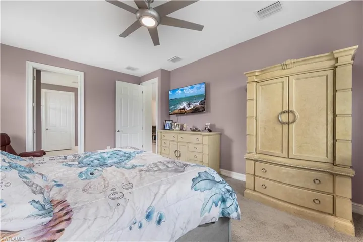 Carpeted bedroom with ceiling fan