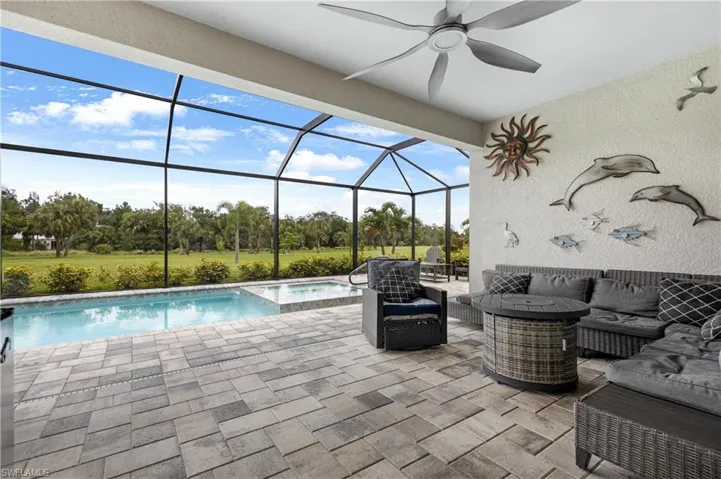 View of pool featuring ceiling fan, a patio, and a lanai