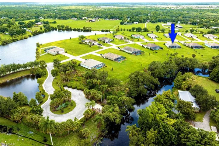 Birds eye view of property with a water view