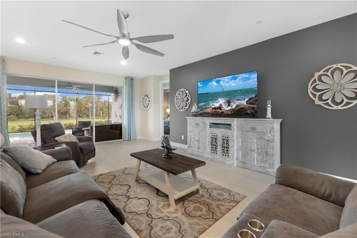 Living room featuring ceiling fan and light tile patterned floors