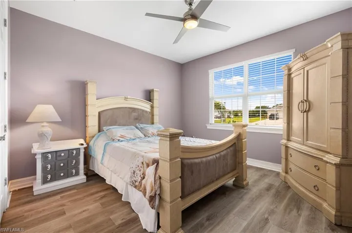 Bedroom with ceiling fan and hardwood / wood-style floors