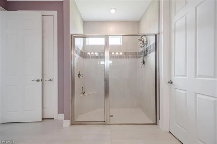 Bathroom with tile patterned flooring and an enclosed shower