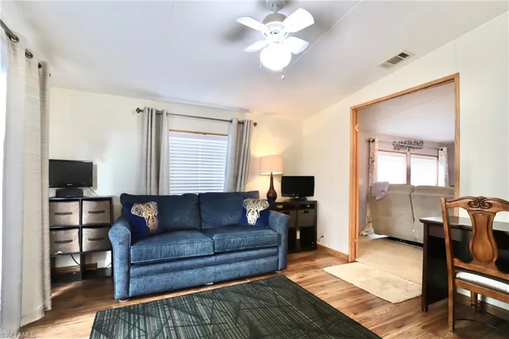 Living room featuring hardwood / wood-style floors and ceiling fan