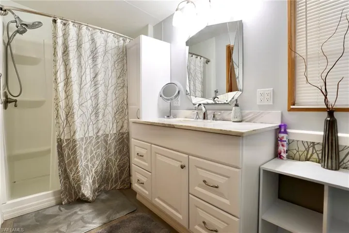 Bathroom with vanity and curtained shower