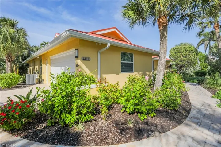 View of property exterior featuring an attached garage and stucco siding