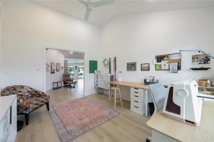 Office featuring light wood-style flooring, high vaulted ceiling, french doors, and ceiling fan