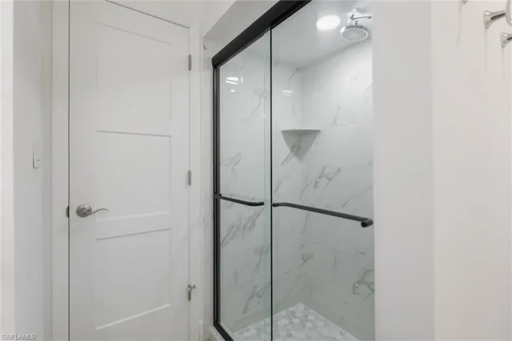 Full bathroom featuring a marble finish shower