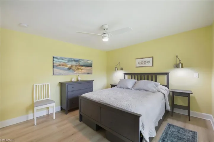 Bedroom with light wood-type flooring and a ceiling fan
