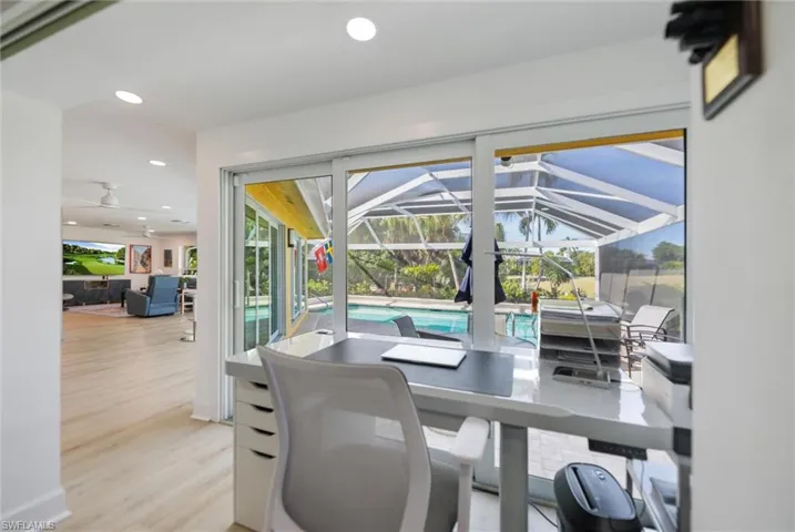 Home office with a sunroom, recessed lighting, plenty of natural light, light wood-type flooring, and a ceiling fan