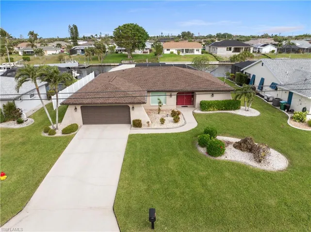 View of front facade with a front yard and a garage