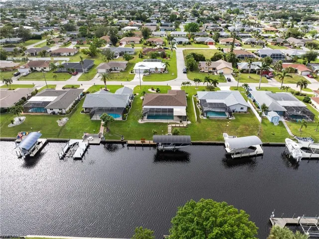 Birds eye view of property with a water view