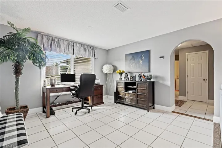 Dining room used as office with light tile flooring