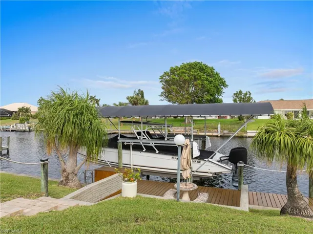 View of dock featuring boat lift and a water view