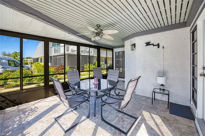 Sunroom featuring a ceiling fan and outdoor dining area