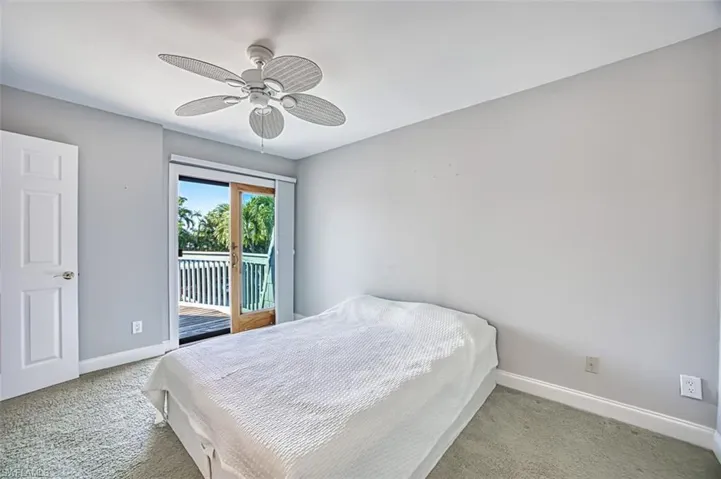 Bedroom featuring carpet flooring, access to exterior, and a ceiling fan