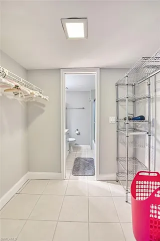 Bathroom with light tile patterned flooring and  shower combination