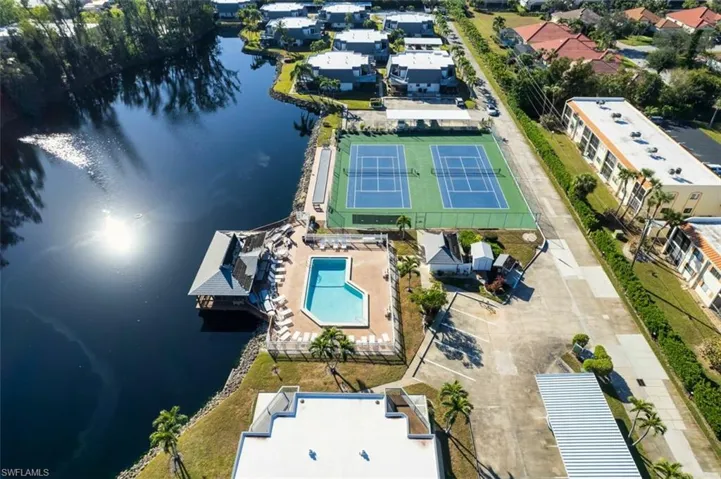 Aerial view of a pool and a large body of water