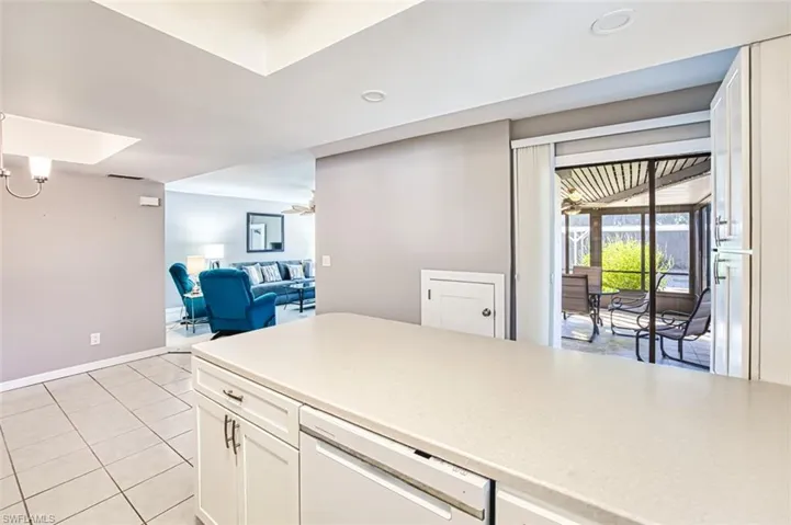 Kitchen featuring white cabinetry, white dishwasher, light tile patterned flooring, open floor plan, and recessed lighting