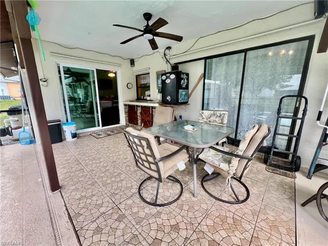 Covered patio by the pool with pass through from the kitchen.