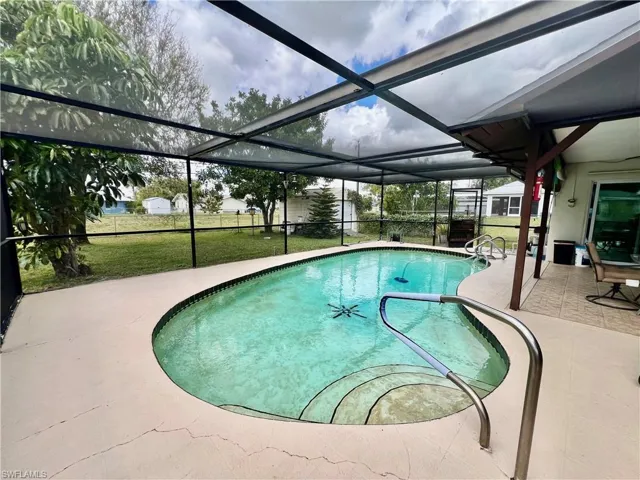 Pool with screen enclosed in ground pool with plenty of privacy.