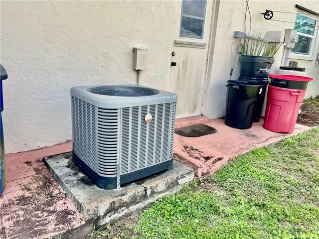 Exterior details with central AC, electric meter, and stucco siding