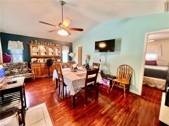 Family room with cathedral ceilings being used as a large formal dining room.