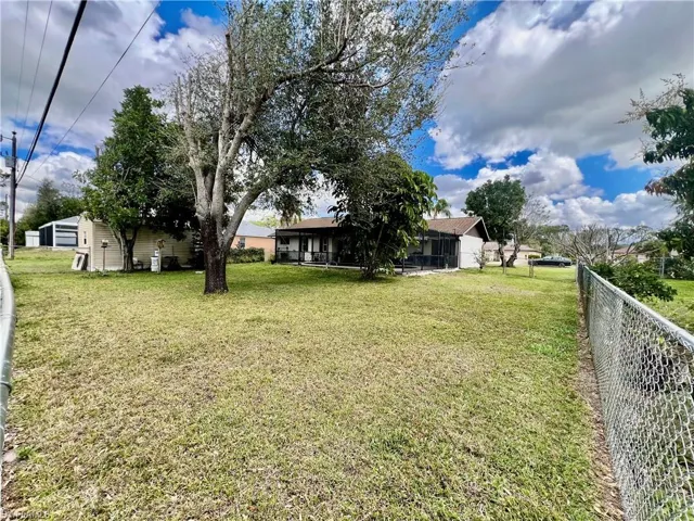View of yard featuring a storage shed and fenced backyard.