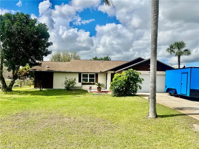 Ranch-style home with a nicely landscaped yard.
