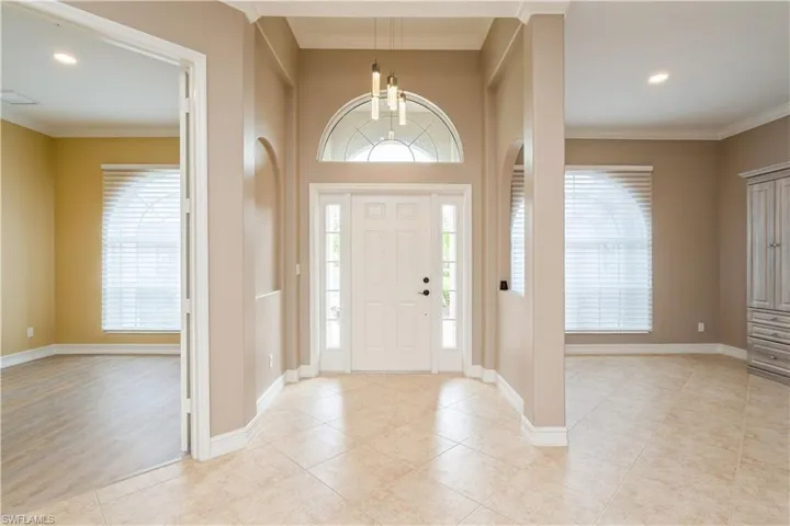 View of foyer, formal dining area and den
