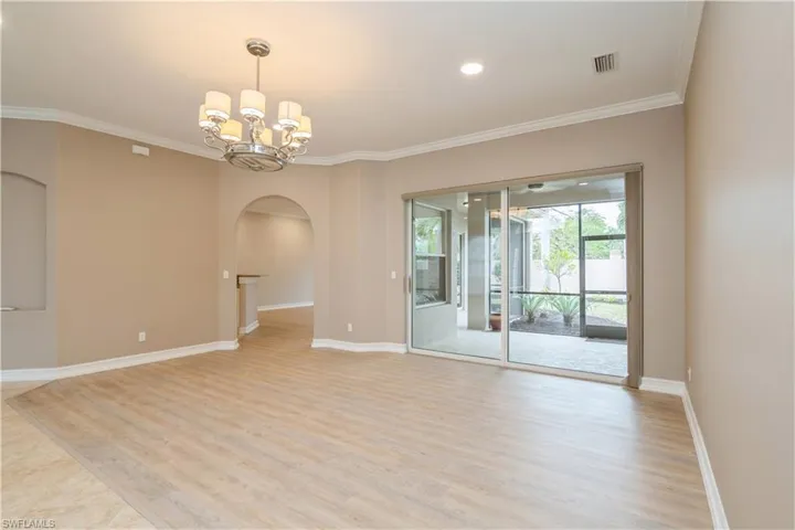Formal living room with arch hallway, crown moulding