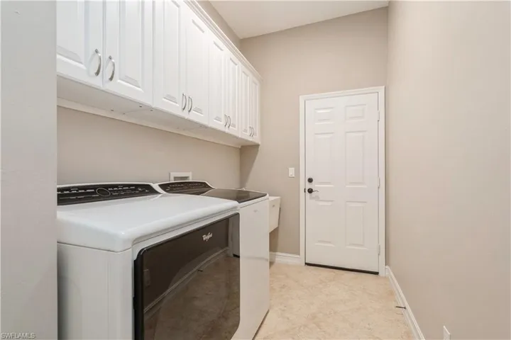 Laundry room with laundry tub & extra cabinets
