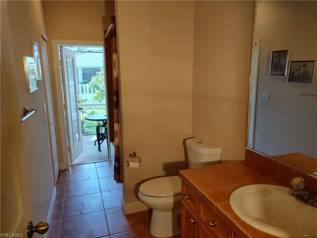Bathroom with tile patterned flooring, vanity, and toilet