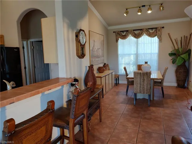 Tiled dining room with crown molding