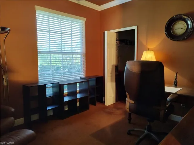 Office area featuring ornamental molding and carpet floors