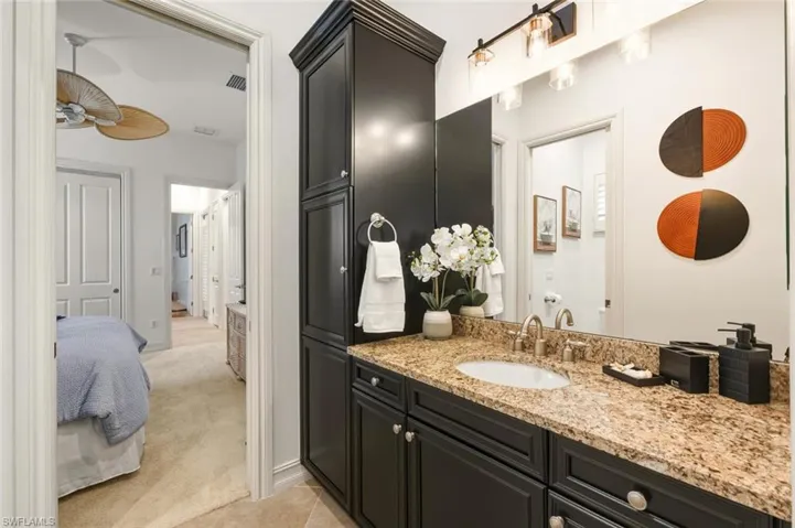 Full bathroom with light carpet, vanity, and ensuite bathroom
