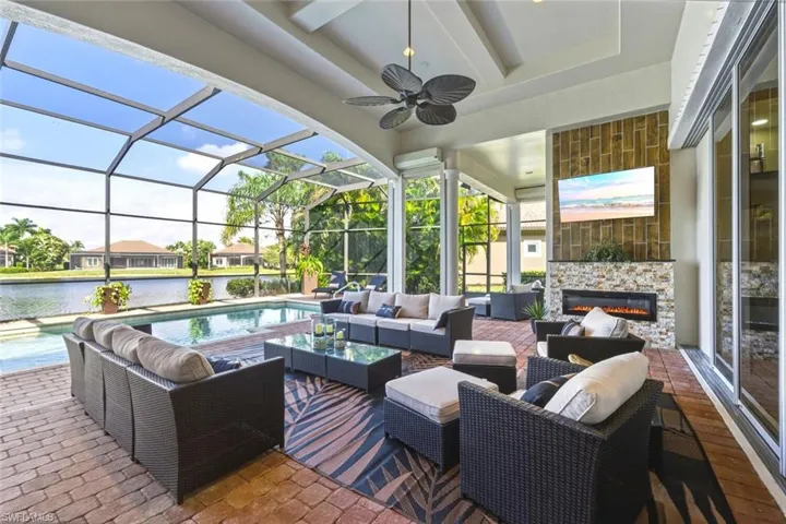 View of patio / terrace featuring an outdoor living space, a sunroom, and glass enclosure