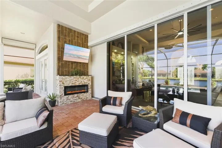 View of patio / terrace featuring an outdoor living space with a fireplace and a ceiling fan