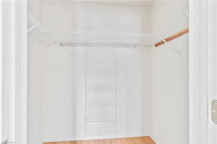 Walk in closet featuring light wood-style floors