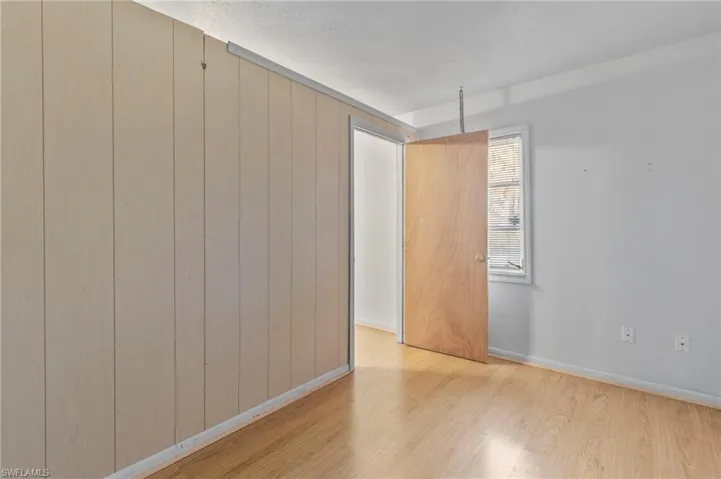 Spare room with light wood-style floors and baseboards