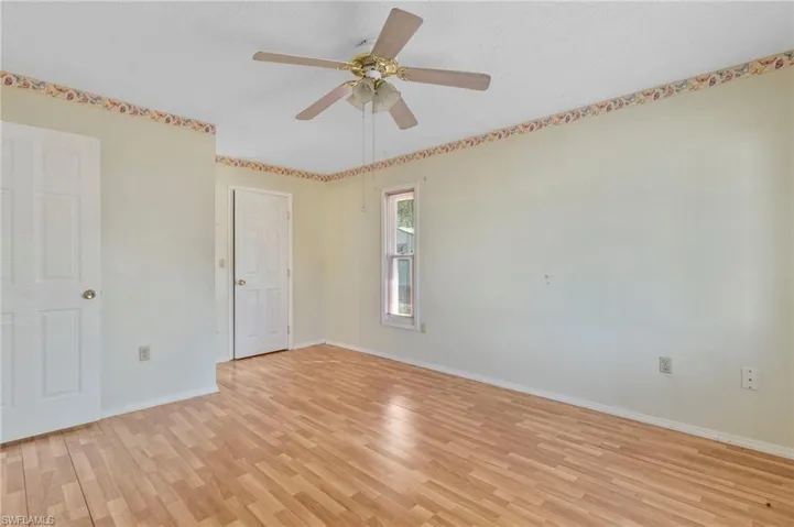 Unfurnished bedroom featuring light wood-style flooring, ceiling fan, and a textured ceiling