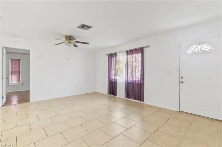 Entrance foyer featuring a ceiling fan and light tile patterned floors