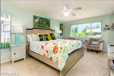 Bedroom featuring a ceiling fan and light carpet