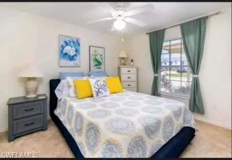 Bedroom featuring light carpet and ceiling fan