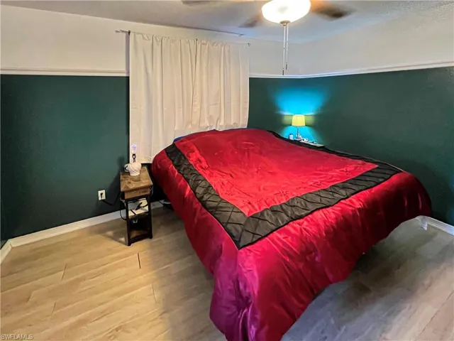 Bedroom featuring ceiling fan and wood-type flooring