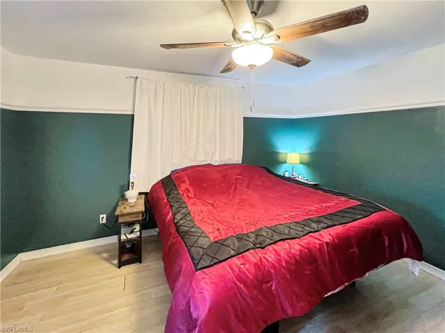 Bedroom featuring hardwood / wood-style floors and ceiling fan