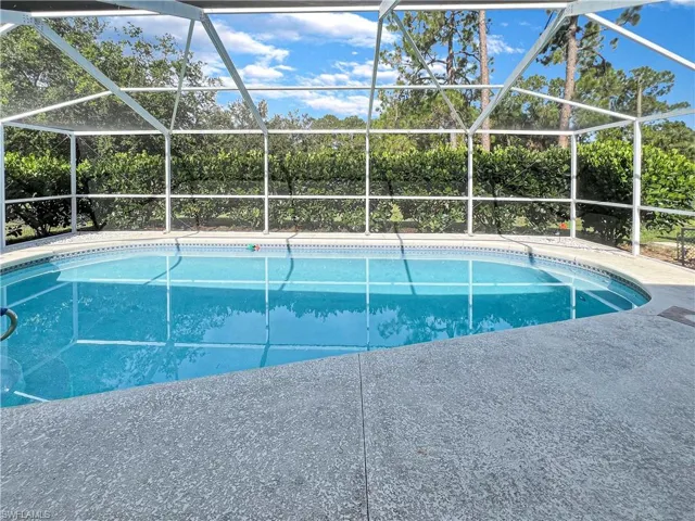 View of swimming pool with a lanai